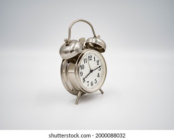 Vintage (~1960s) Soviet stainless steel wind-up alarm clock on a white background.  - Powered by Shutterstock