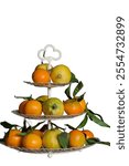 Vintage 3 tiers fruit basket with corsican lemons and mandarins on white background.