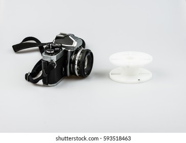Vintage 35mm analog camera and developing spiral