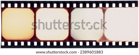 Vintage 35mm old film negative strip with four horizontal frames, sprocket holes, light leaks, dust, scratches, grain. For frames, borders, design, cinema.
