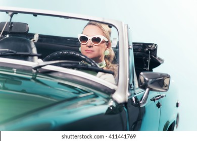 Vintage 60s Fashion Woman With Shades Driving Sports Car.