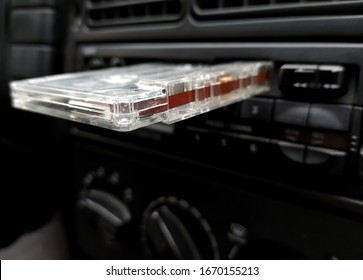 Vintage 90's Cassette Tape Placed On A Car Radio Cassette