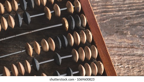 Vintage abacus on an wooden background photo