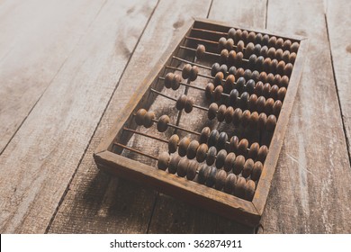Vintage abacus on wooden background