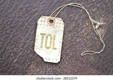 Vintage Airline Luggage Tag On An Antique Suitcase. Toledo, OH Wrote On The Label.