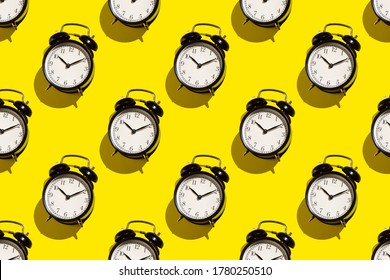 Vintage Alarm Clock On Yellow Background. Abstract Pattern.