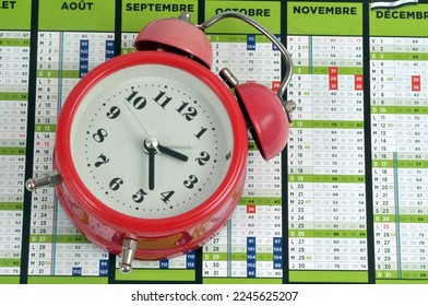 Vintage alarm clock placed on a french calendar - Shutterstock ID 2245625207