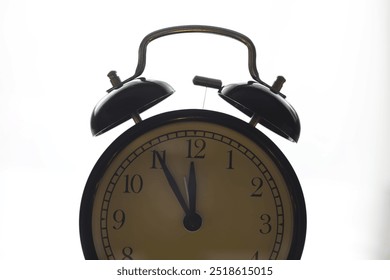 Vintage Alarm Clock Showing Five Minutes to Midday on White Background - Powered by Shutterstock