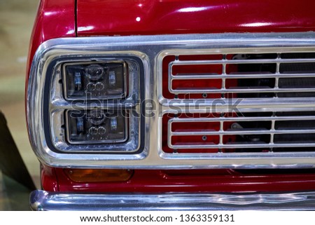 Vintage American car. Close-up of headlights and grille.