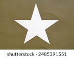 Vintage American white military star on a WW2 truck door, khaki green background and white star foreground, single star middle shot, old and vintage.