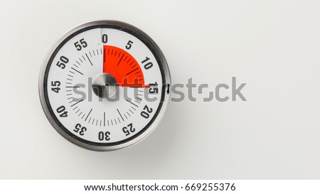Vintage analog kitchen countdown timer with classical clock face and red remaining time display, 15 minutes left