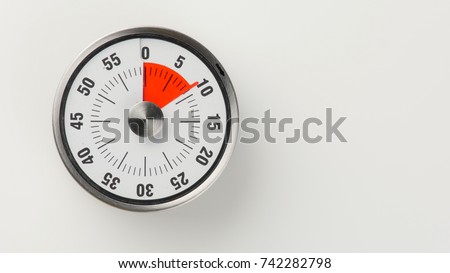 Vintage analog kitchen countdown timer with classical clock face and red remaining time display, 9 minutes left, close up shot with copy space