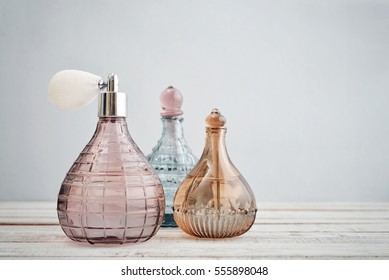 Vintage antique bottles with perfume on blue background