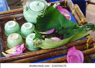 Vintage Antique Celadon Glazed Porcelain Tea Set With Lotus Flower Tea On A Lotus Leaf And Pink Lotus Petals On A Bamboo Tray