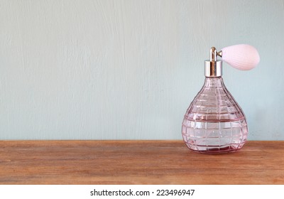 vintage antique perfume bottle on wooden table.