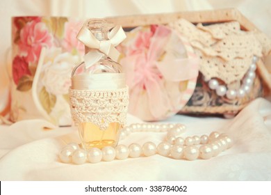 Vintage antique perfume bottles, on wooden table. retro filtered image