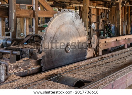 Vintage, Antique Steam Powered Sawmill and Large Saw Blade for Cutting Timber.