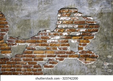 Vintage Architectural Grunge: Old Brick Exposed Beneath Thin Concrete Fallen Off Face Of Exterior Wall