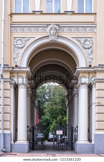 Vintage architecture classical facade. Beaux\
Art arch and cast-iron gate. Front view.\
Translate: Fire passage.\
The gate does not\
obstruct.