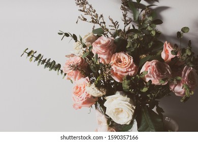vintage aromatic dried rose flower and natural leaf with white wall in valentine's day love romantic concept, wedding decoration flora tree - Shutterstock ID 1590357166