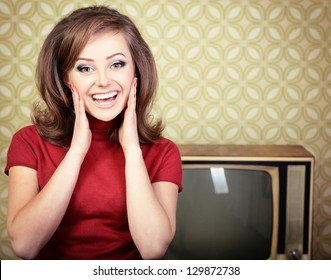 Vintage Art Portrait Of Young Smiling Woman Looking Out At Camera In Room With Wallpaper And Tv Set From 70s, Retro Stylization, Toned