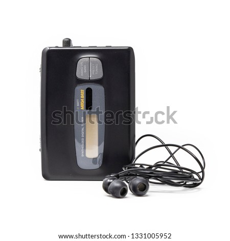 Vintage audio player. Old fashioned portable cassette player, cult object, icon and symbol of the 80s and 90s. Headphones isolated on white background.