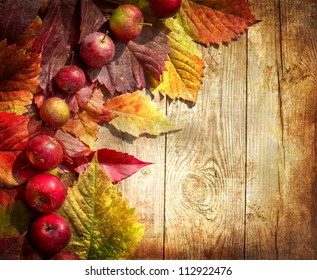 Vintage Autumn Border From Apples And Fallen Leaves On Old Wooden Table/Thanksgiving Day Concept/background With Apples