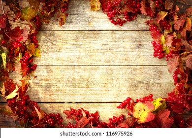 Vintage Autumn Border From Ashberry And And Fallen Leaves On Old Wooden Table/Thanksgiving Day Concept/