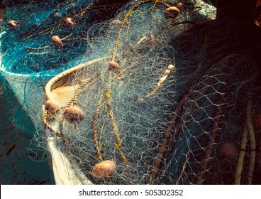 Vintage background - fishing nets for marine concept about craft of fishermen in retro style. Sea nets - fishing equipment or tackle as texture with cross-process effect.