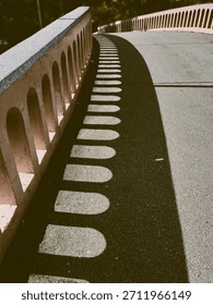 Vintage background image of light and shadow created by archways in the cement walls of the arched bridge walkway.