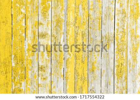 Vintage background yellow color from wooden batten. Old wood slats with paint cracks