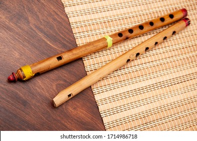 Vintage Bamboo Fife And Flute Lie On A Straw Mat