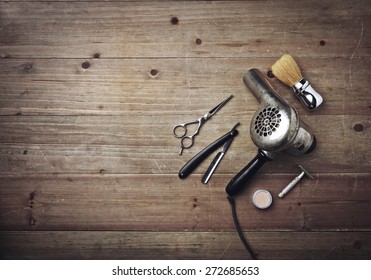 Vintage barber equipment on wood background with place for text