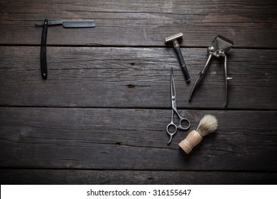 Vintage barber shop equipment on wood background with place for text