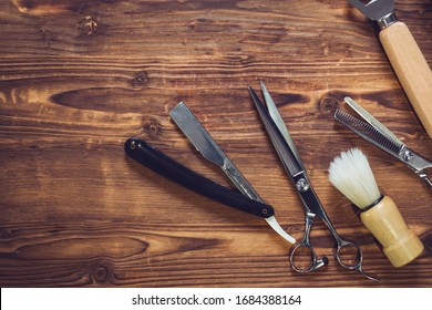 Vintage barber shop tools on wood background 
