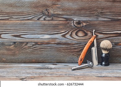 Vintage barber shop tools on old wooden background with copy space