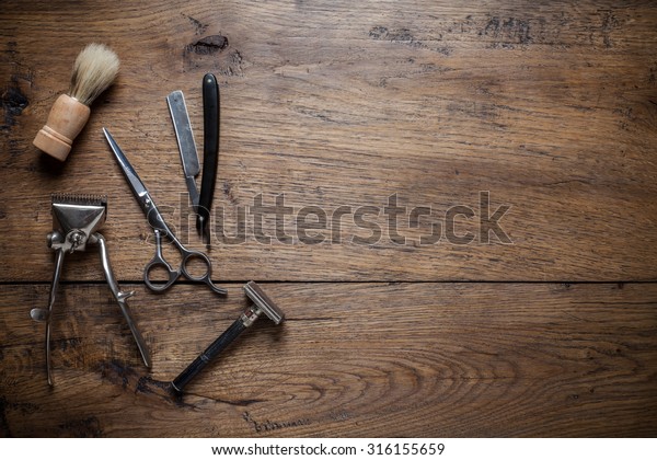 Vintage barber shop tools on wood background with\
place for text