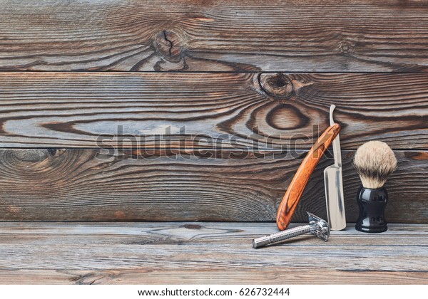 Vintage barber shop tools on old wooden background\
with copy space