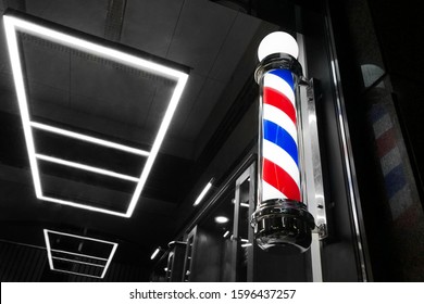 Vintage Barbershop Window Pole. Old-fashioned Barber Pole In The Window, Night Shot, Selective Focus.
