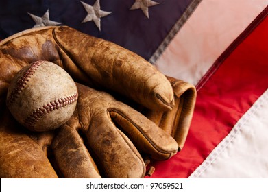 Vintage baseball and glove on American flag
