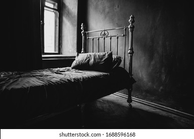 Vintage Bed In Empty Bedroom. Black And White Horizontal Photo.