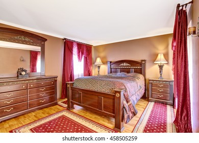 Vintage Bedroom Interior With Wooden Furniture, Red Curtains And Rugs. Northwest, USA