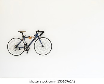 Vintage bicycle hanging on white wall for decoration - Powered by Shutterstock