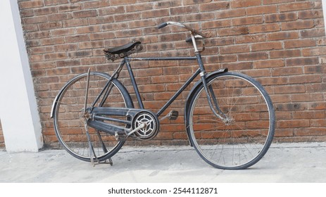 Vintage bicycle leaning against weathered brick wall. - Powered by Shutterstock