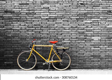 Vintage bicycle on roadside with black and white brick wall background