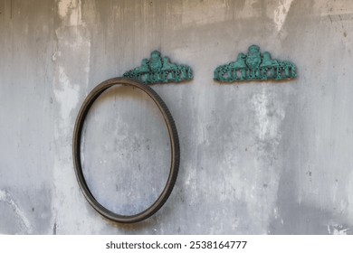 Vintage Bicycle Tire on Weathered Wall with Ornamental Hooks - Powered by Shutterstock