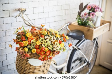 Vintage bicycle with welcome sign, on vintage white brick wall, Vintage bicycle with flowers in basket, vintage and pastel toned - Powered by Shutterstock