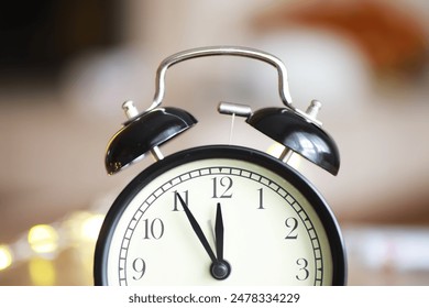 Vintage Black Alarm Clock at 11:55 with Blurred Background - Powered by Shutterstock