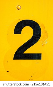 vintage black number two painted over yellow ghost number eight on metal