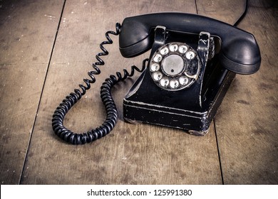 Vintage Black Phone On Old Wooden Table Background